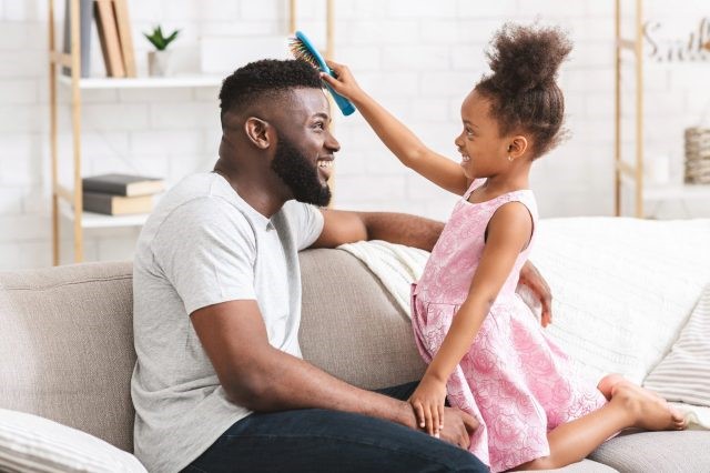 Dad and daughter doing hair