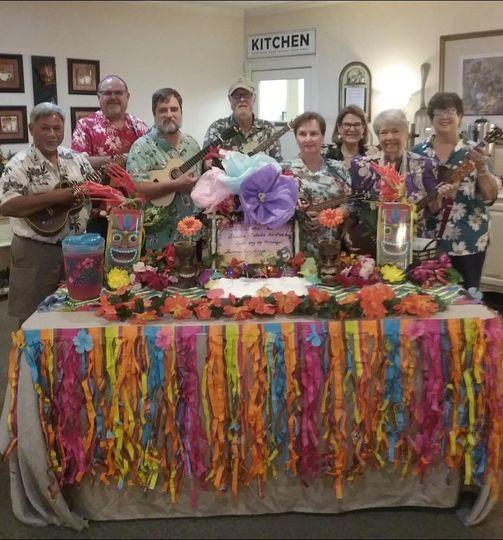 group in a luau setting with ukeleles